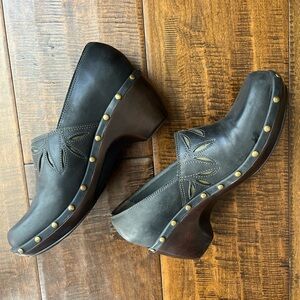 Nurture dark gray leather clogs with gold studs and cutout leaf details